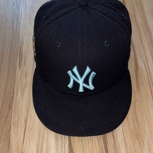 New York Yankees men’s 7 5/8 fitted side patxh fitted hat with light blue tones.